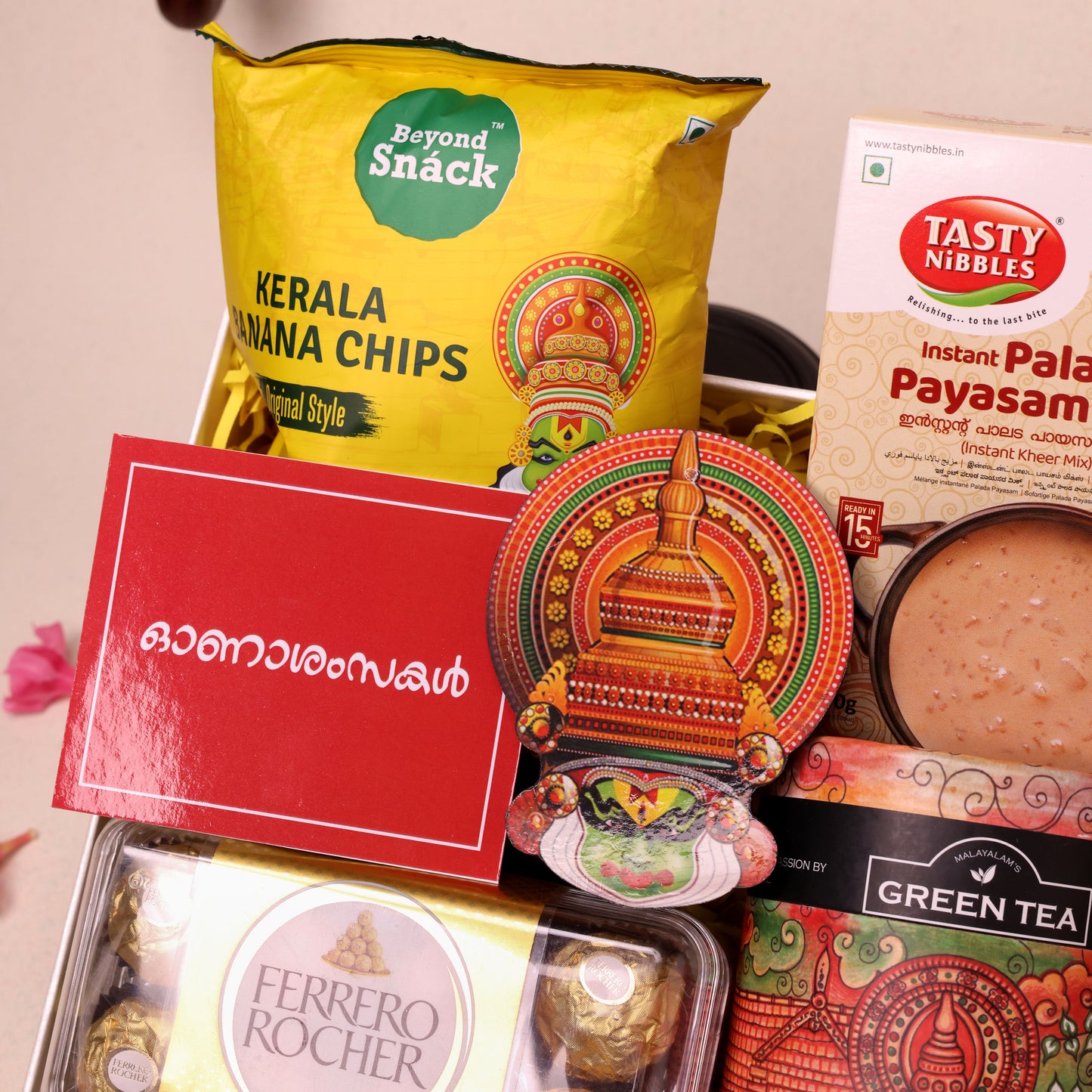 Utharadam Onam Gift Hamper with Green Tea, Chocolates, Banana Chips & Kathakali Wall Décor | Colorful Painted Katakali Head Wall Décor | Artistic Onam Accent