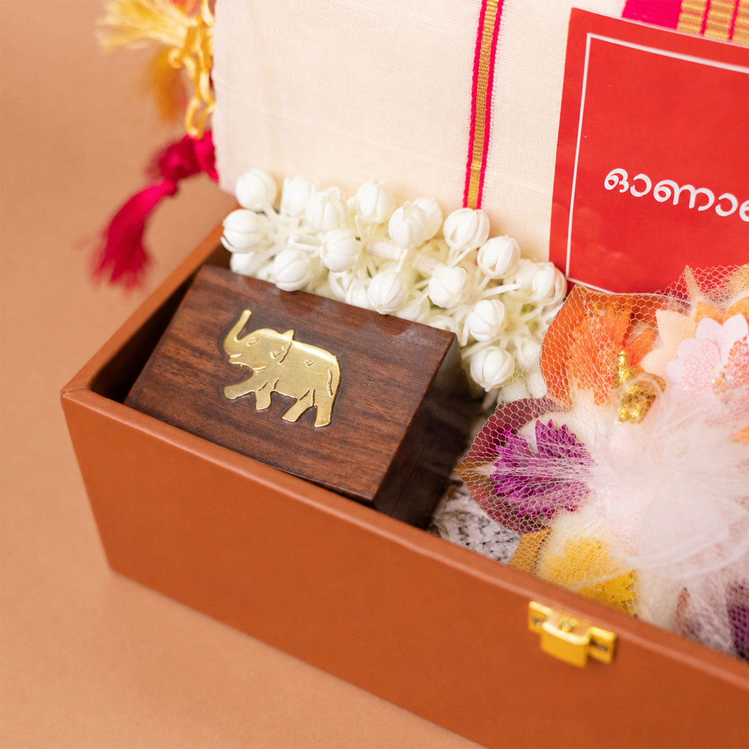 Onakodi For Her Premium Onam Gift Hamper with Saree, Jewellery Box, Bangles and Lotus Uruli Candle