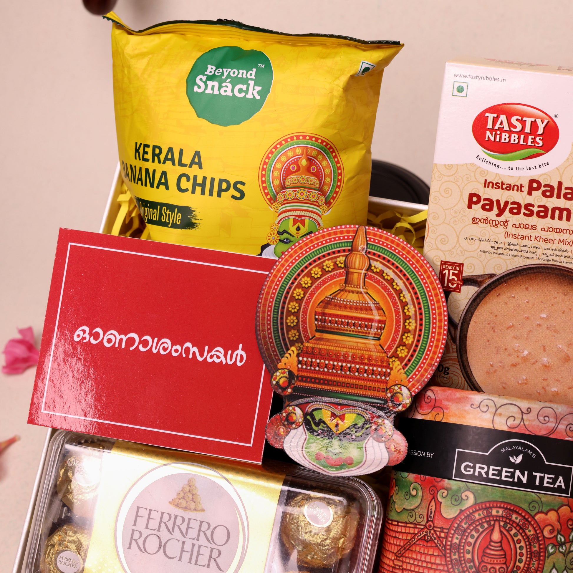 Utharadam Onam Gift Hamper with Green Tea, Chocolates, Banana Chips & Kathakali Wall Décor  | Colorful Painted Katakali Head Wall Décor | Artistic Onam Accent